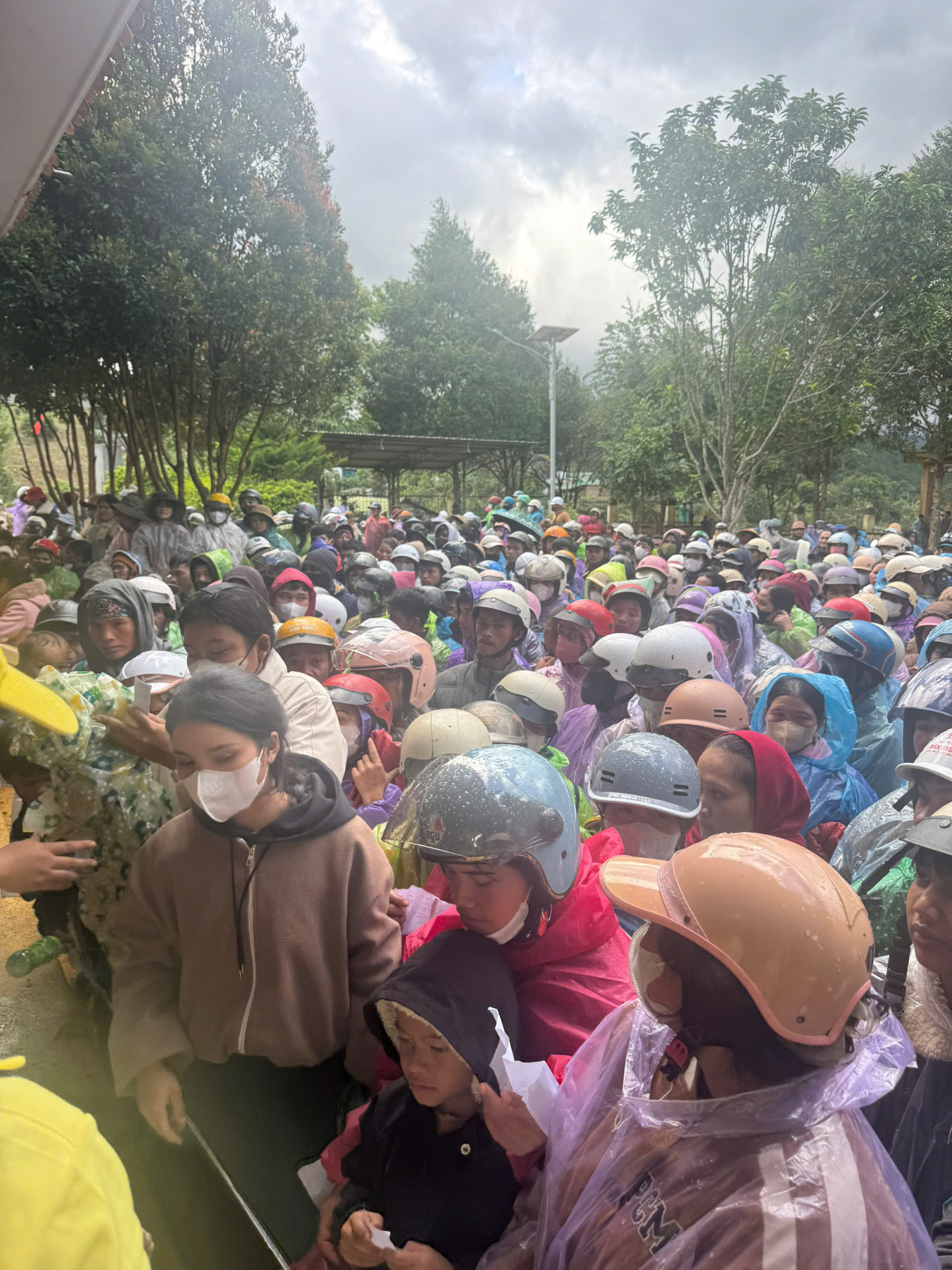 Hundreds of villagers gathered in the rain waiting for the distribution