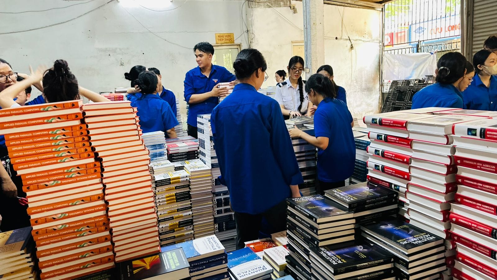 Volunteers sorting 30,000 donated World Scientific Publishing books